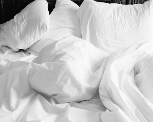 A dark cozy bedroom interior promoting deeply relaxed and comfortable sleep